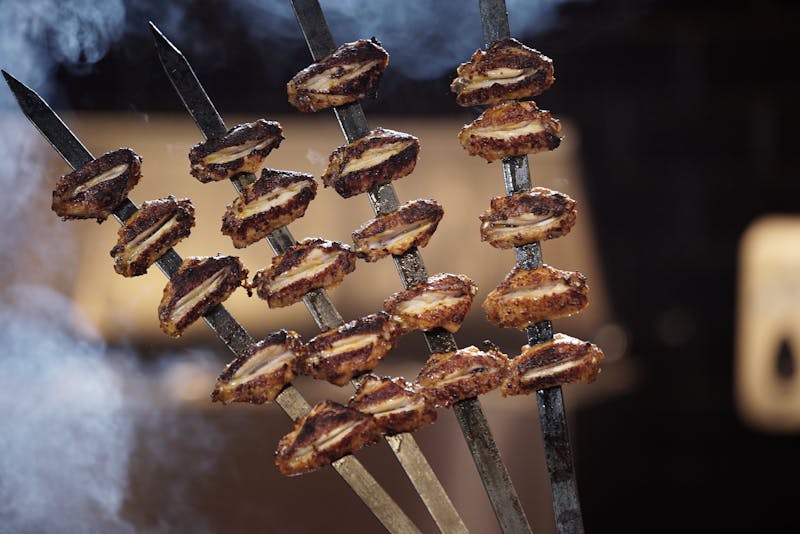 Family gathered around a table sharing a big plate of wings